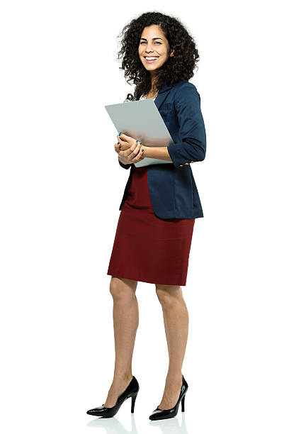 feliz empresaria de pie con un portapapeles - businesswoman skirt isolated standing fotografías e imágenes de stock