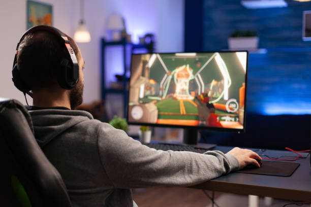 istock Player using keyboard and mousepad to play video games 1811487510