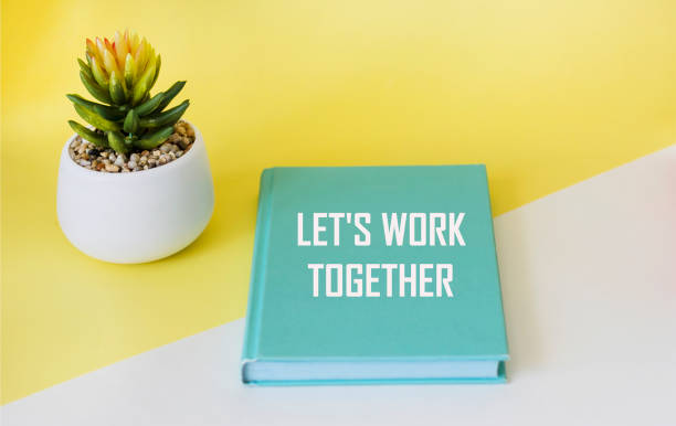 istock Let's work together written on a green notepad and a yellow and white background. 1811492774