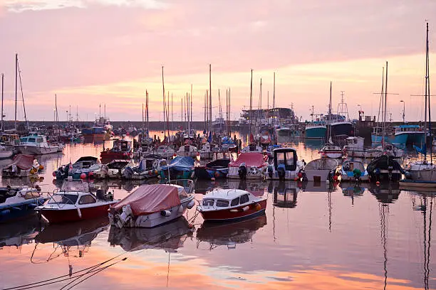 Yachts and fishing boats moored in the harbour at Bridlington, East Yorkshire, England.