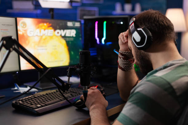 istock Man losing video games and streaming with live chat 1811493411