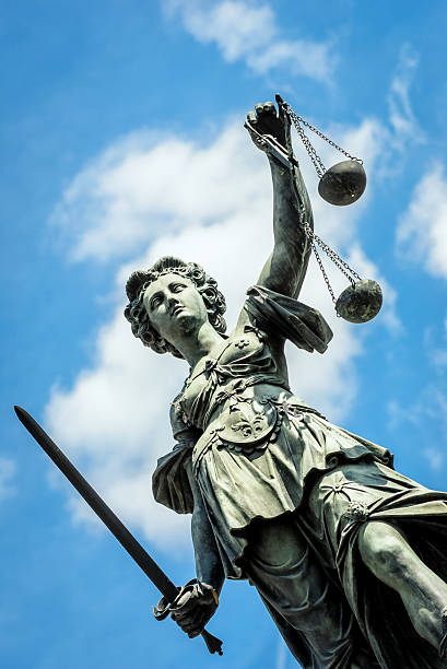 istock Low angle of view of a statue representing justice under sky 181149415