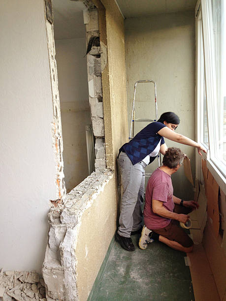 istock Couple Protecting Balcony During Home Addition Europe 181149547