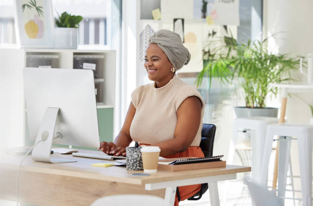 istock Business, happy or black woman typing on computer working on search engine or online project research. SEO technology, smile or mature African journalist writing blog reports or internet articles 1811500167