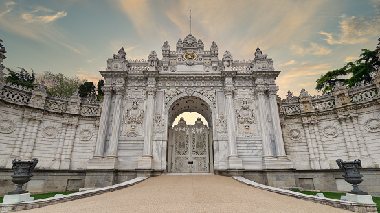 Sunrise shot of closed gate at former Ottoman Dolmabahce Palace, or Dolmabahce Sarayi, suited in Ciragan Street, Besiktas district, Istanbul, Turkey. View from the internal court