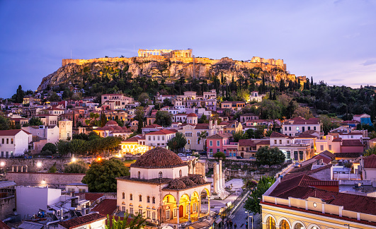 The Acropolis and many parts of Athens floodlit in the blue hour following sunset, with te Parthenon in the upper centre of the image.