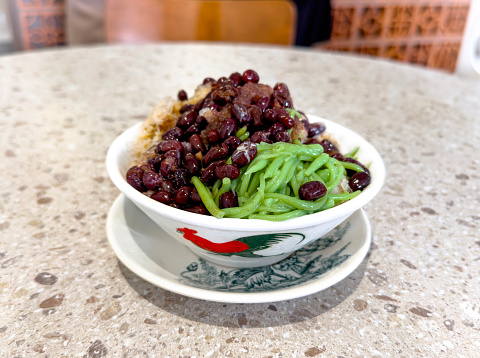 Malaysia traditional local dessert called Cendol. Cendol is made from crushed ice cubes, sugar gula Melaka, red beans, pandan green rice flour jelly on top.