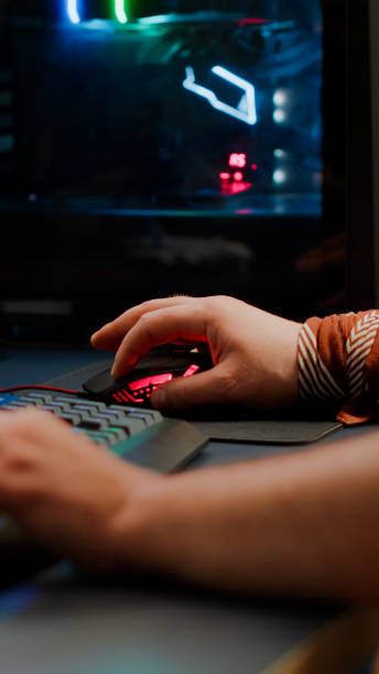 istock Close up of player hands using RGB keyboard in gaming home studio 1811509932
