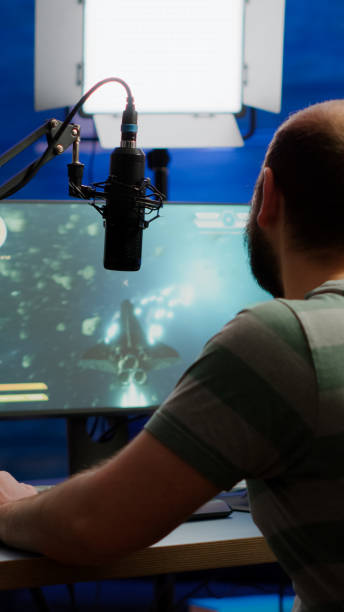 istock Streamer performing space shooter videogame on RGB powerful computer 1811511671
