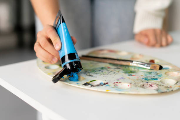 パレットのチューブから色とりどりの絵の具を絞り出すアーティストの手 - painter pallet paint oil paint ストックフォトと画像