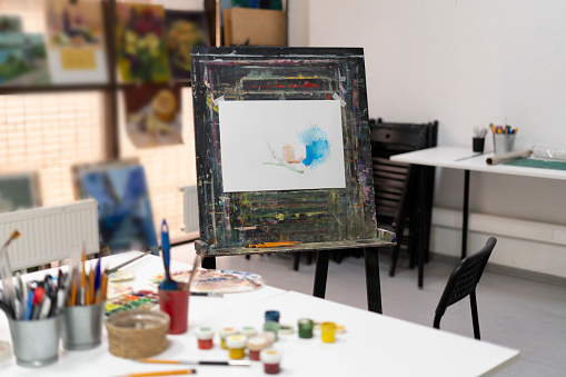 artist's workplace in the studio with different paints and brushes