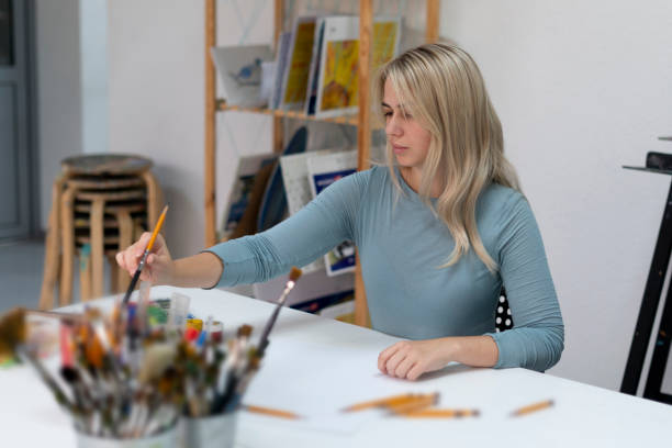 istock artist's hand chooss and pick up the pencil from a jar 1811512302