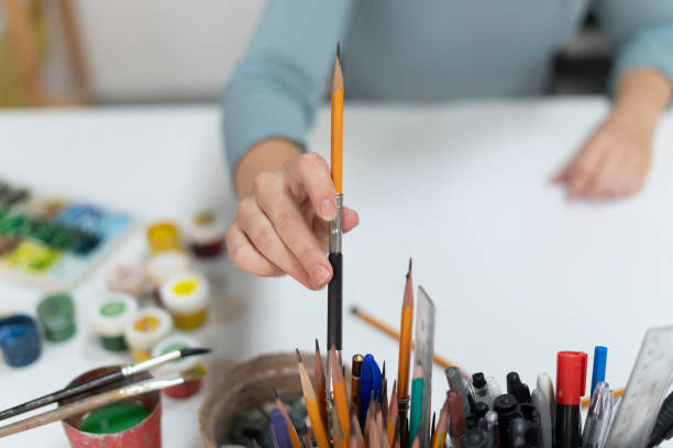 istock artist's hand chooss and pick up the pencil from a jar 1811512307