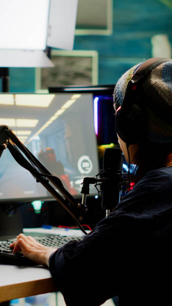 istock Pro streamer checking sound on mixer and putting on headset 1811515113