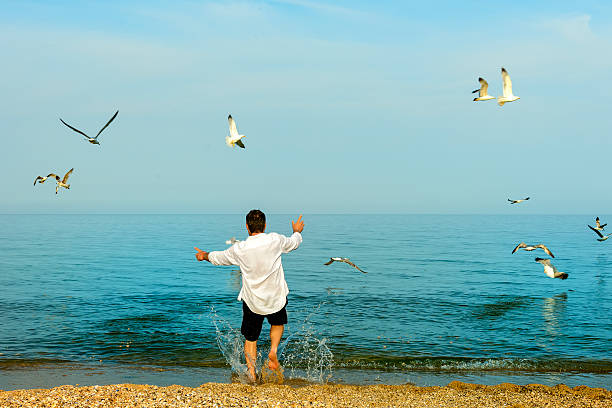 istock man running to sea side 181151612