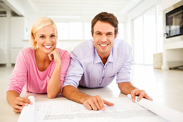 istock Couple With Blueprint Lying On Floor At Home 181151616