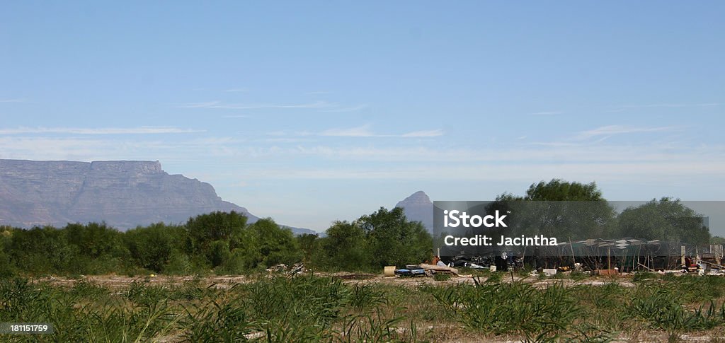 Living in the bush "People living in slums, Table Mountain and Lions Head at the background. Cape Town, South Africa" Child Stock Photo