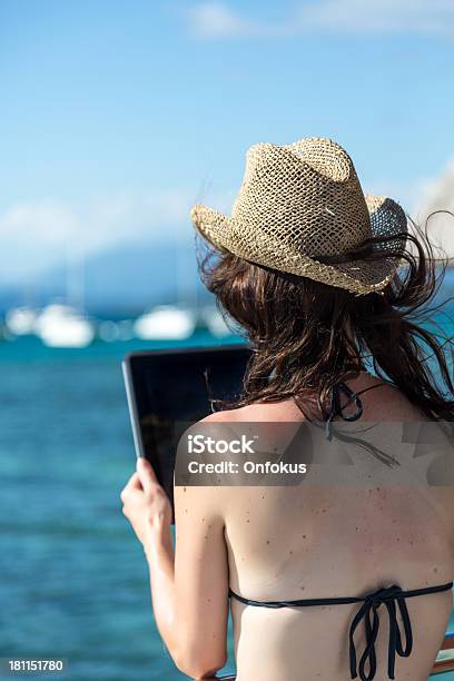 Woman Using An Electronic Tablet On Over Water Bungalow Balcony Stock Photo - Download Image Now