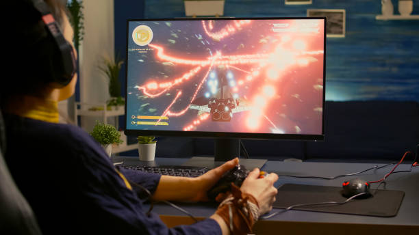istock Over shoulder of focused cyber player wearing headset 1811522090