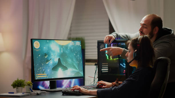 istock Man gamer teaching his girlfriend playing space shooter video game 1811522108
