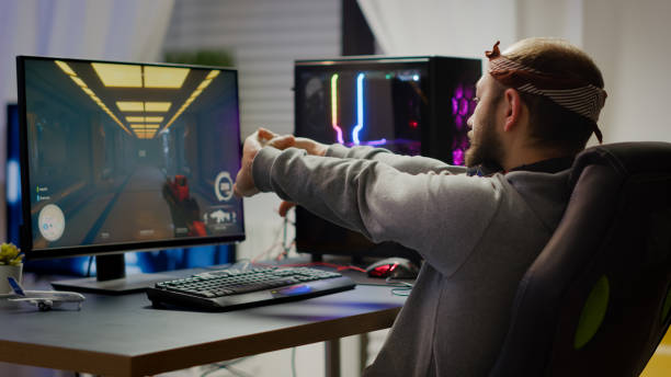 istock Competitive gamer streatching hands sitting on gaming chair 1811525334