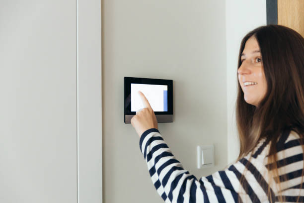 istock Woman Using Smart Home Devise at Her Modern Apartment 1811525972