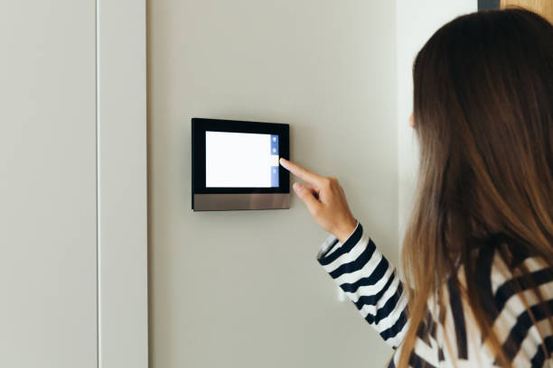istock Woman Using Smart Home Devise at Her Apartment 1811526002