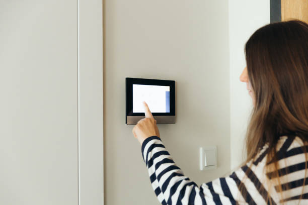 istock Woman Using Smart Home Devise at Her Modern Apartment 1811526246