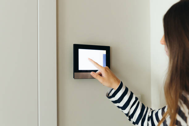 istock Woman Using Smart Home Devise at Her Modern Apartment 1811526523