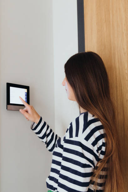 istock Woman Using Smart Home Devise at Her Modern Apartment 1811527159