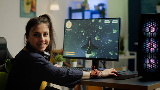 istock Woman gamer with headset looking at camera smiling 1811527699