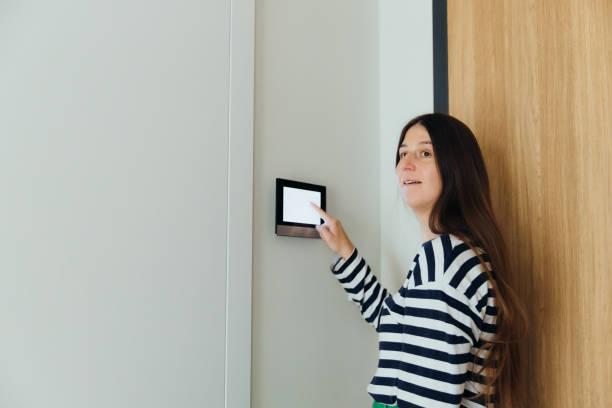 istock Woman Using Smart Home Devise at Her Modern Apartment 1811527703