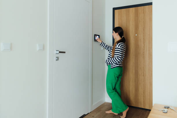 istock Woman Using Smart Home Devise at Her Modern Apartment 1811529942