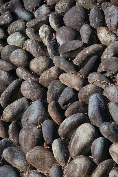 istock A stone wall made up of many round stones 1811533207