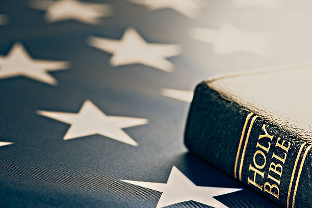 Holy Bible with American Flag stock photo