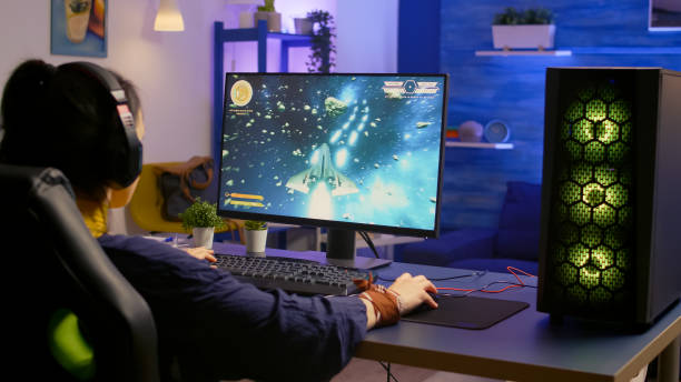 istock Gamer playing space shooter video game on powerful computer 1811537759