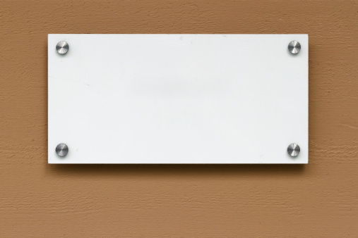 Blank sign on wall, includes clipping path.