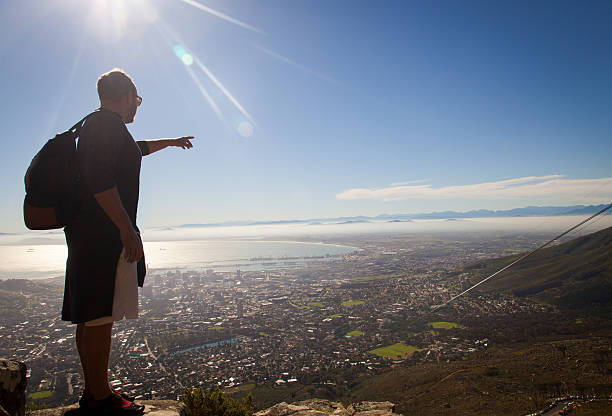 istock Hiker Looking Over Cape Town City Centre Pointing 181154295