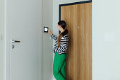 Woman Using Smart Home Devise at Her Modern Apartment