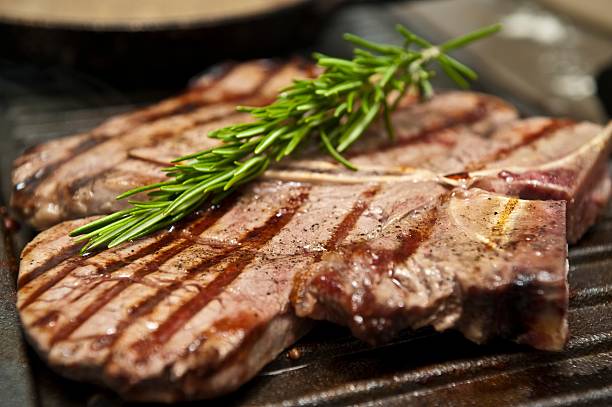 T-Bone Steak T-Bone Steak cooking on a Grill fire alphabet letter t stock pictures, royalty-free photos & images