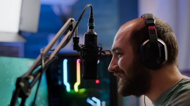 istock Pro streamer sitting on gaming chair talking with players using micorphone 1811547770