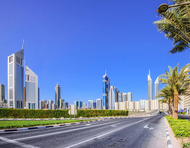 Dubai Street and Skyline Empty street and modern skyline along the Sheikh Zayed Road in Dubai, UAE dubai street stock pictures, royalty-free photos & images