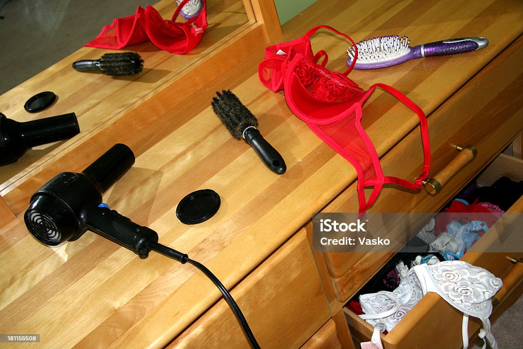 Getting Ready for a Date Picture of a messy dresser as a girl gets ready for a date.  Adult Stock Photo