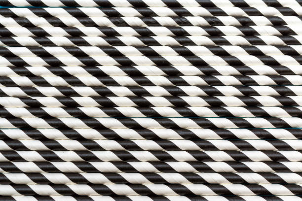 istock A lot of cocktail striped black and white tubes. Pattern background flat lay. 1811564132