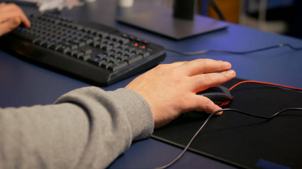 istock Close-up on hands of player man using professional RGB mouse 1811566252