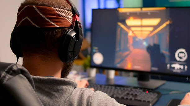 istock Pro gamer playing on powerful computer shooter video game 1811573336