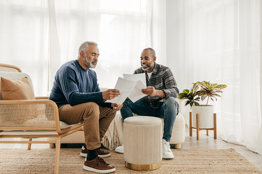 Senior men meeting with a financial advisor  at home