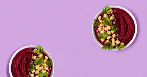 istock Smoothie bowl with beetroot and chickpea on the purple background. Top view. Copy space. 1811591516
