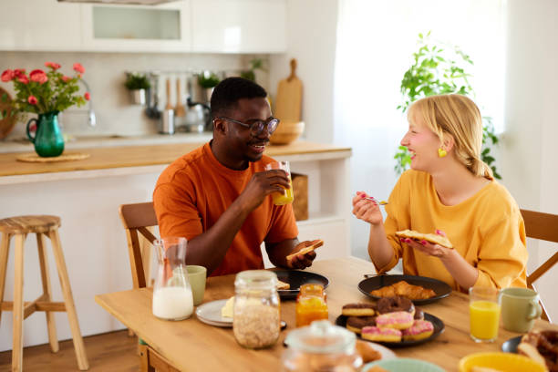 istock Multiracial couple enjoying breakfast together at home 1811606108