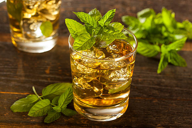 A glass of homemade gourmet mint julep Homemade Gourmet Fresh Mint Julep Alcoholic Cocktail mint julep photos stock pictures, royalty-free photos & images